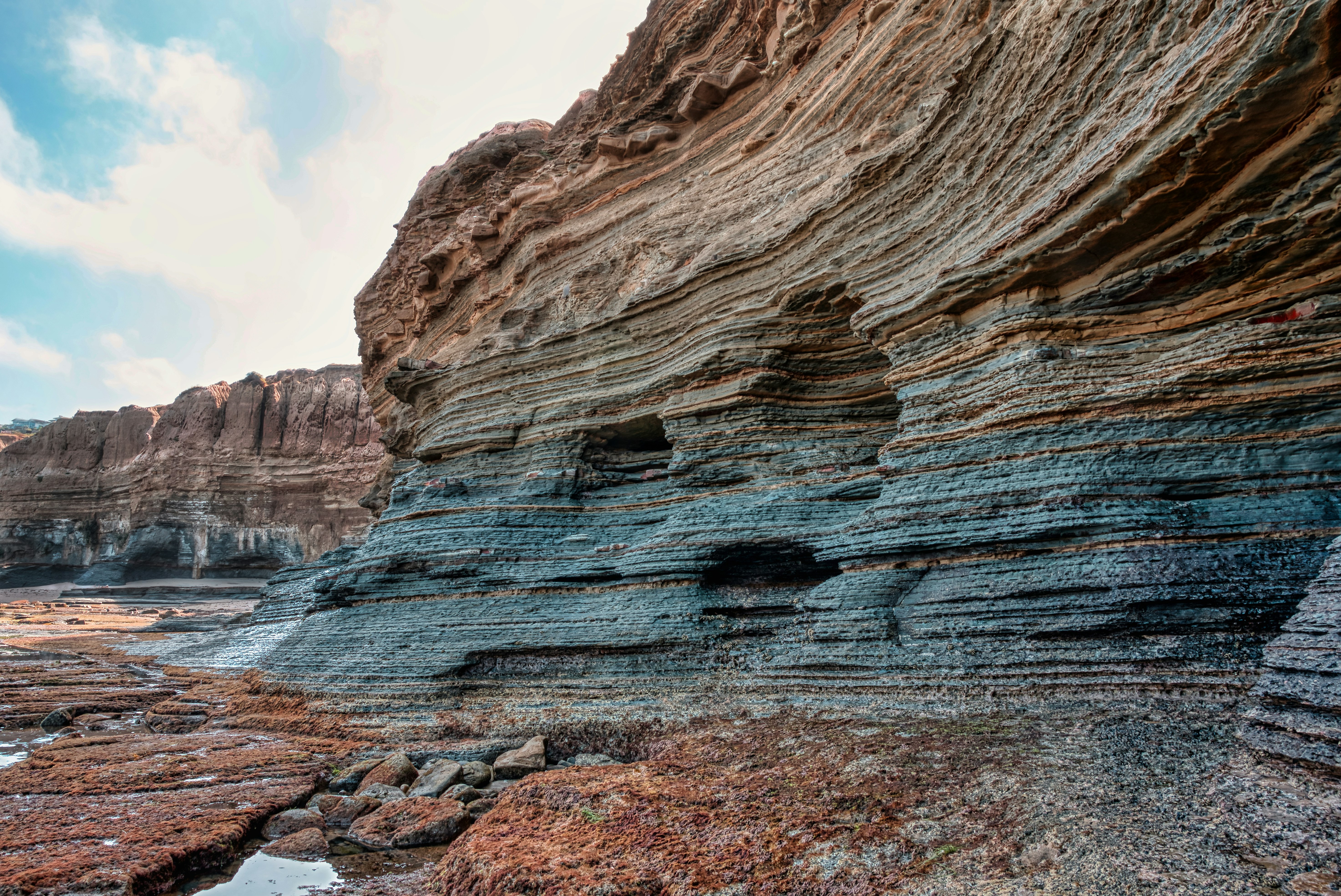 brown rock formation near body of water during daytime